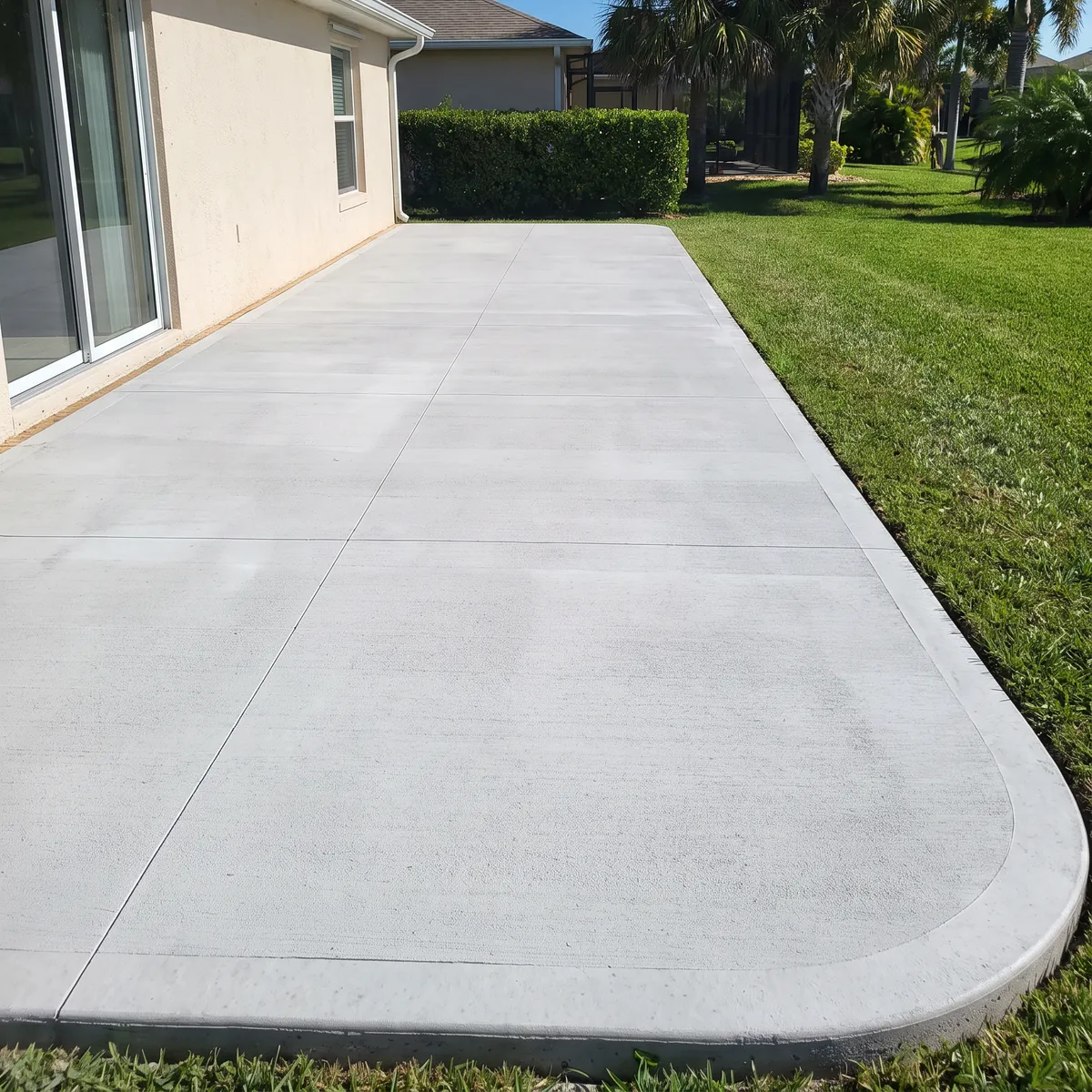 A broom-finish concrete patio behind a Florida home